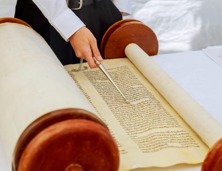 Jewish man dressed in ritual clothing 5 SEPTEMBER 2016 USA NY Hand of boy reading the Jewish Torah at Bar Mitzvah Bar Mitzvah Torah reading